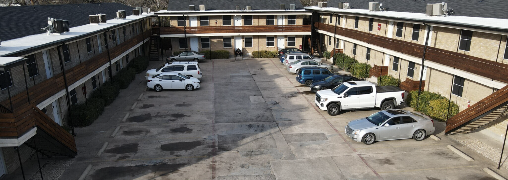 an aerial view of a parking lot with cars at The Hampton Gardens