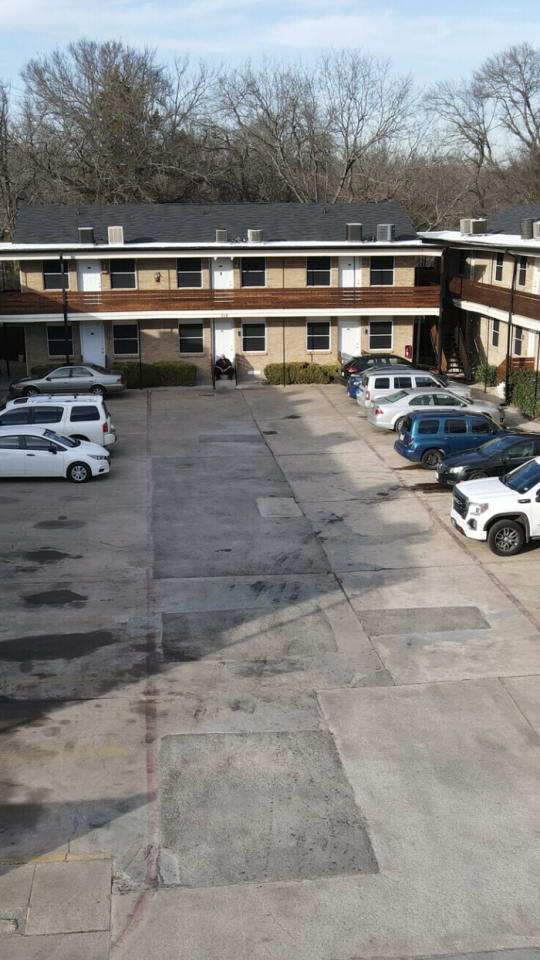 an aerial view of a parking lot with cars at The Hampton Gardens