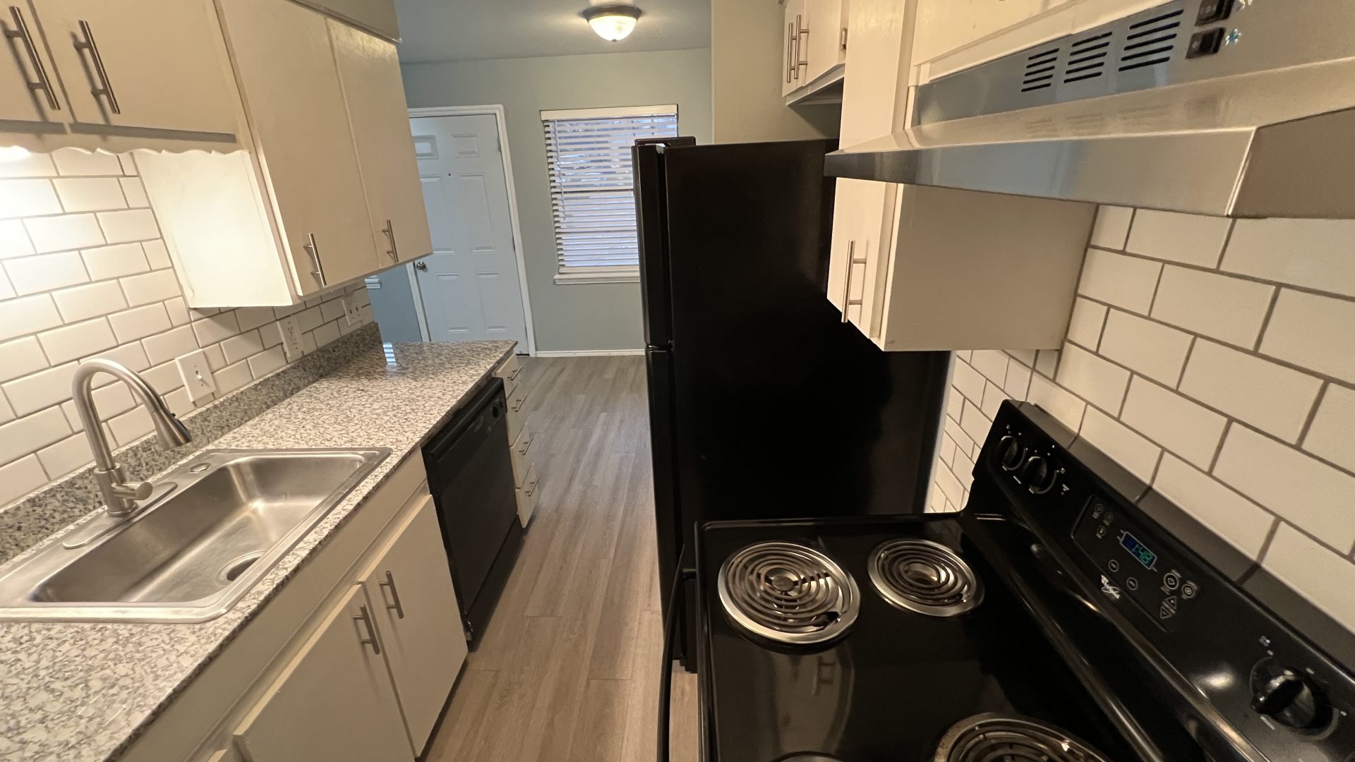 a kitchen with a stove, oven, and microwave at The Hampton Gardens