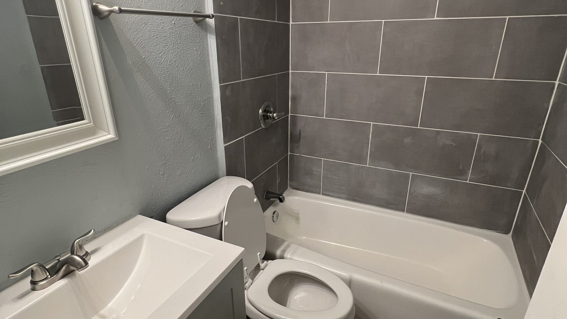 a bathroom with a toilet, sink and shower at The Hampton Gardens